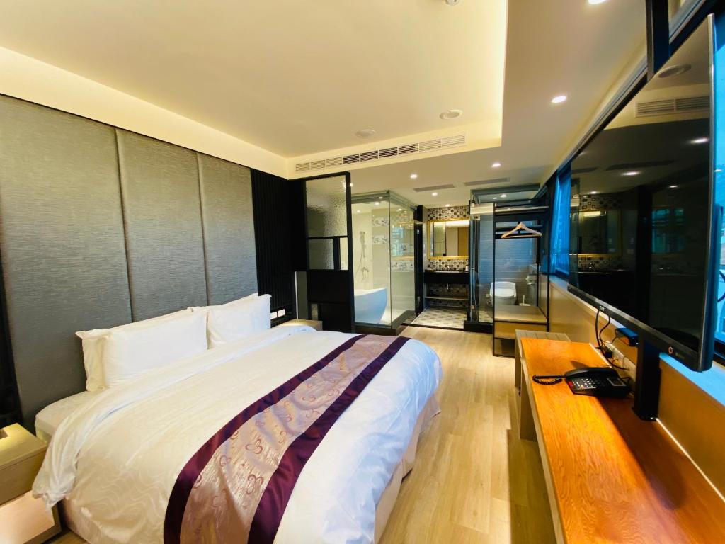 Postel nebo postele na pokoji v ubytování Cai Mei Hotel