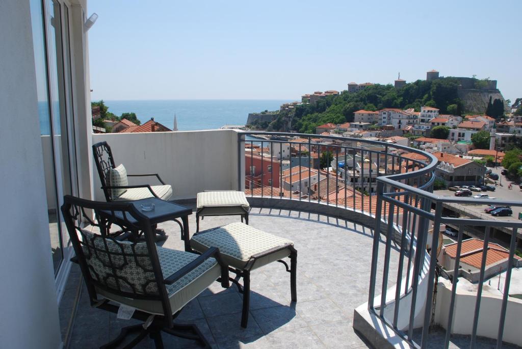 a balcony with chairs and a view of the ocean at Apartments Ismy in Ulcinj