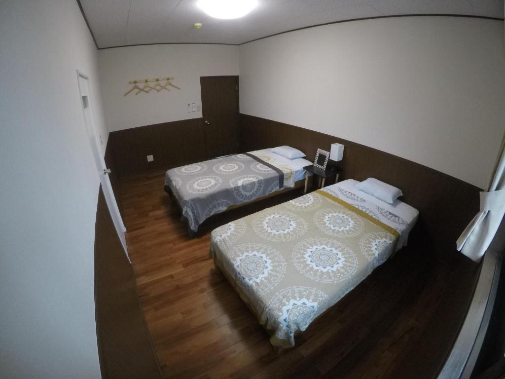 Postel nebo postele na pokoji v ubytování 宮古島ゲストハウス cocoikoi