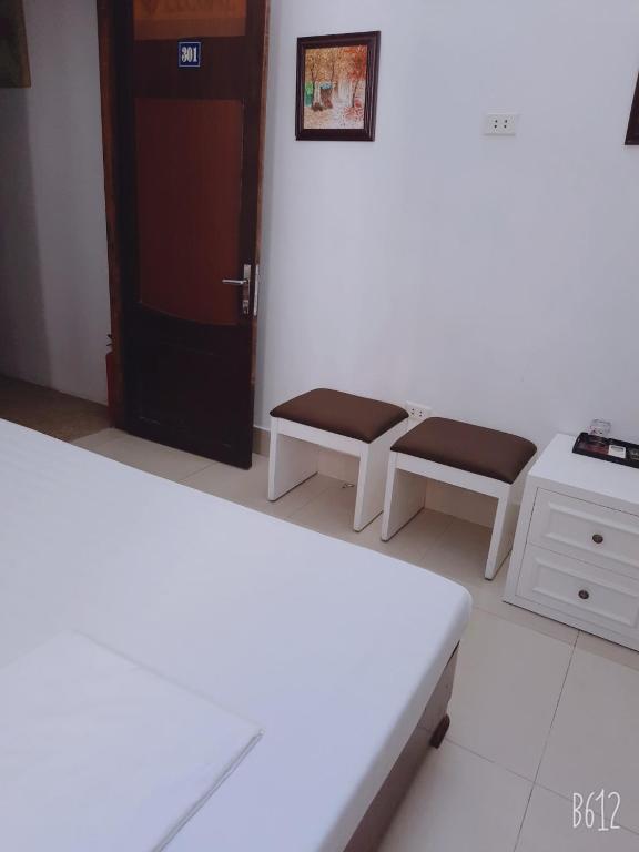 Postel nebo postele na pokoji v ubytování Hanoi Carina Hotel