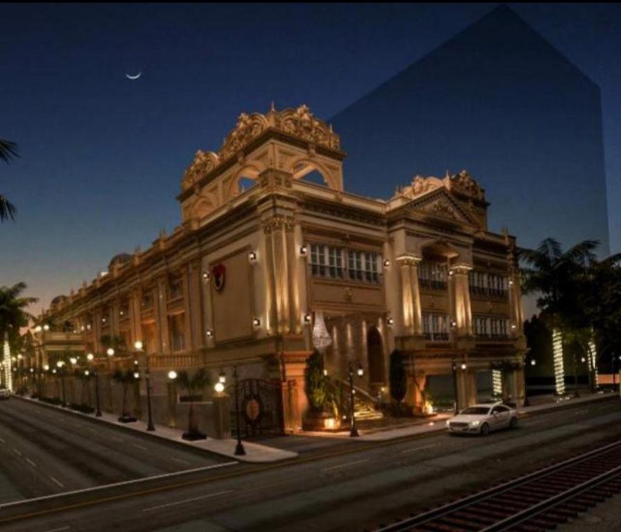 a large building on a city street at night at Royal Jewel Al Raml Hotel in Alexandria