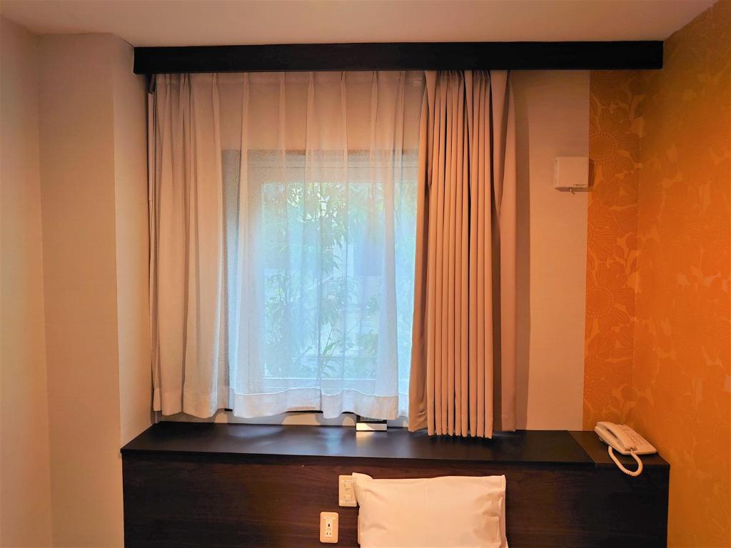 Postel nebo postele na pokoji v ubytování Ueno Frex Hotel