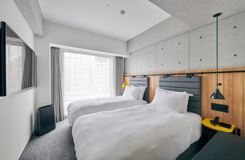 Postel nebo postele na pokoji v ubytování ibis Styles Nagoya