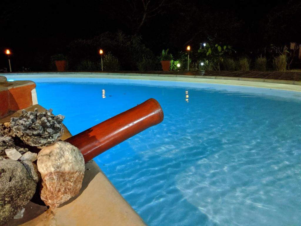 a swimming pool with a baseball bat in the water at Hotel Lakana Ramena in Antsiranana