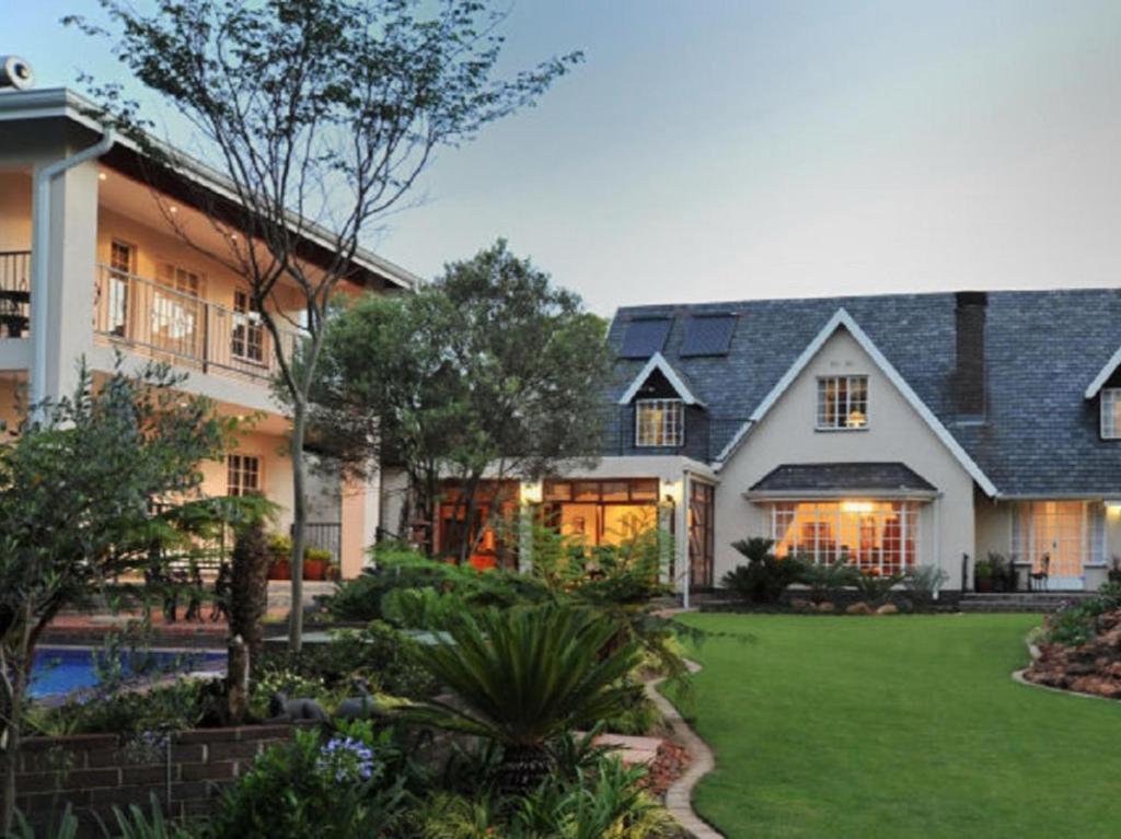 an exterior view of a house with a yard at Gallo Manor Executive Bed & Breakfast in Johannesburg