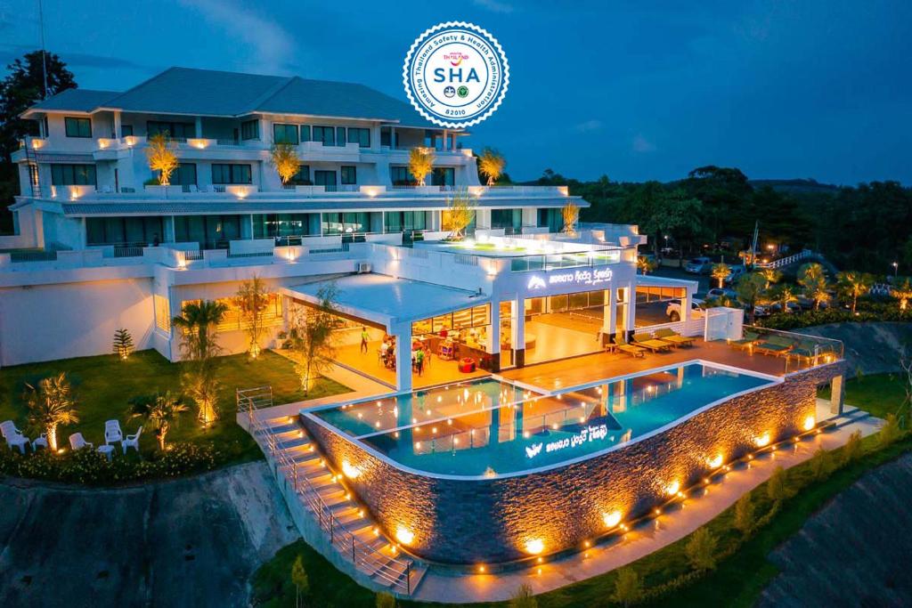 a large building with a swimming pool at night at Soidao Good View Resort in Ban Thap Sai