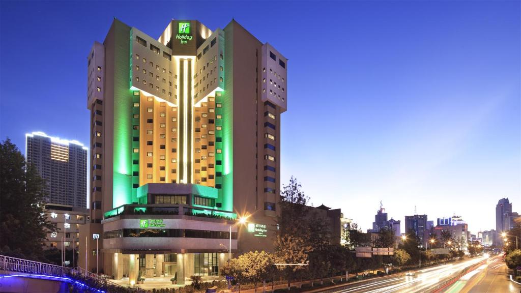 a large building with green lights on top of it at Holiday Inn Kunming City Centre, an IHG Hotel in Kunming
