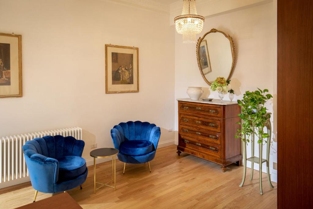 ローマにあるDomus Serafinoのリビングルーム(青い椅子2脚、ドレッサー付)