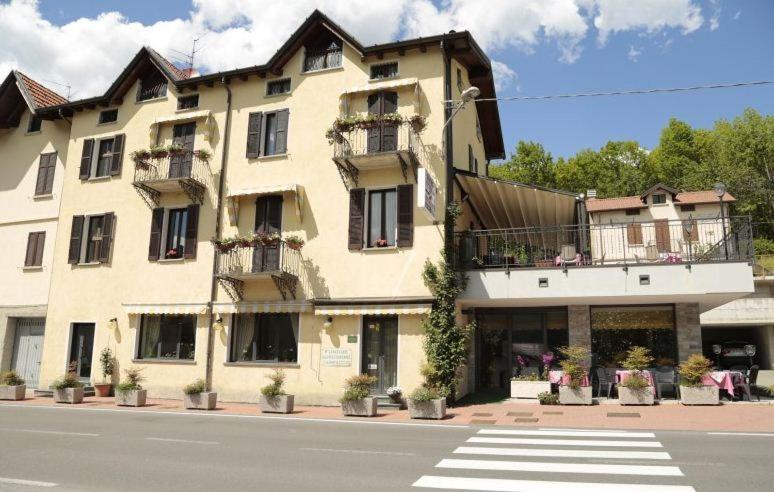 a large building on the side of a street at Hotel Ristorante Vittoria in San Fedele Intelvi