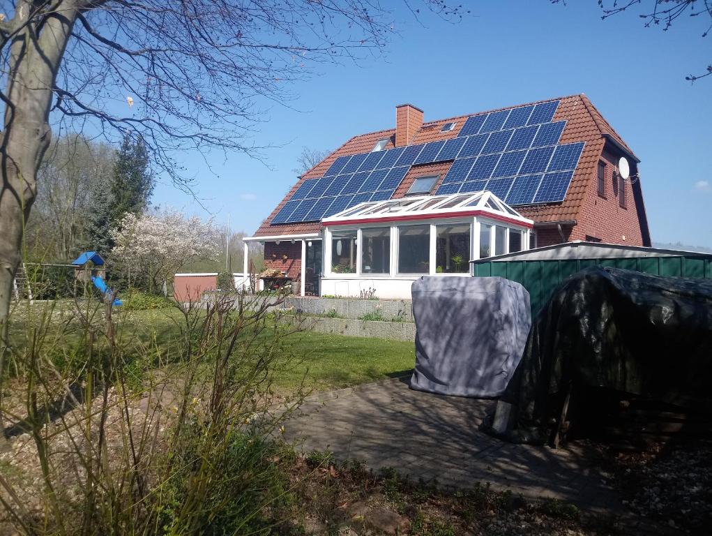 a house with a lot of solar panels on the roof at Apartment an den Teichen in Lengede