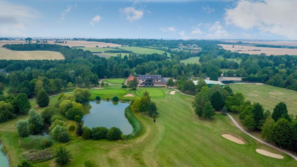 an aerial view of a golf course with a pond at Lakeside Lodge in Pidley