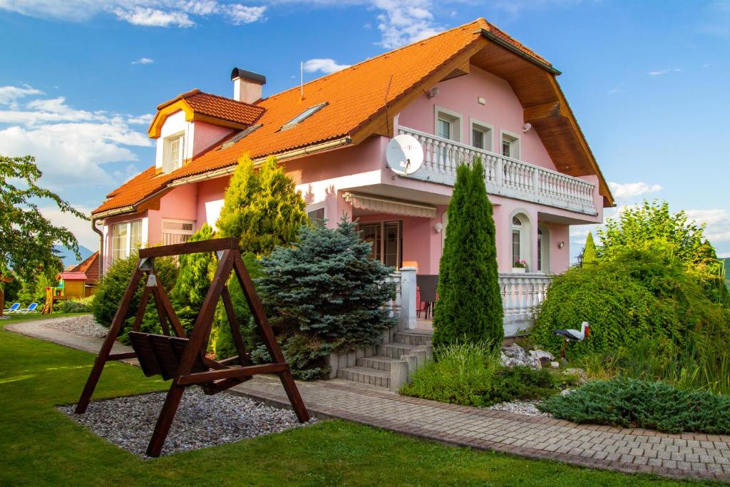 a pink house with an orange roof at WOW Liptov Holiday House in Liptovský Mikuláš