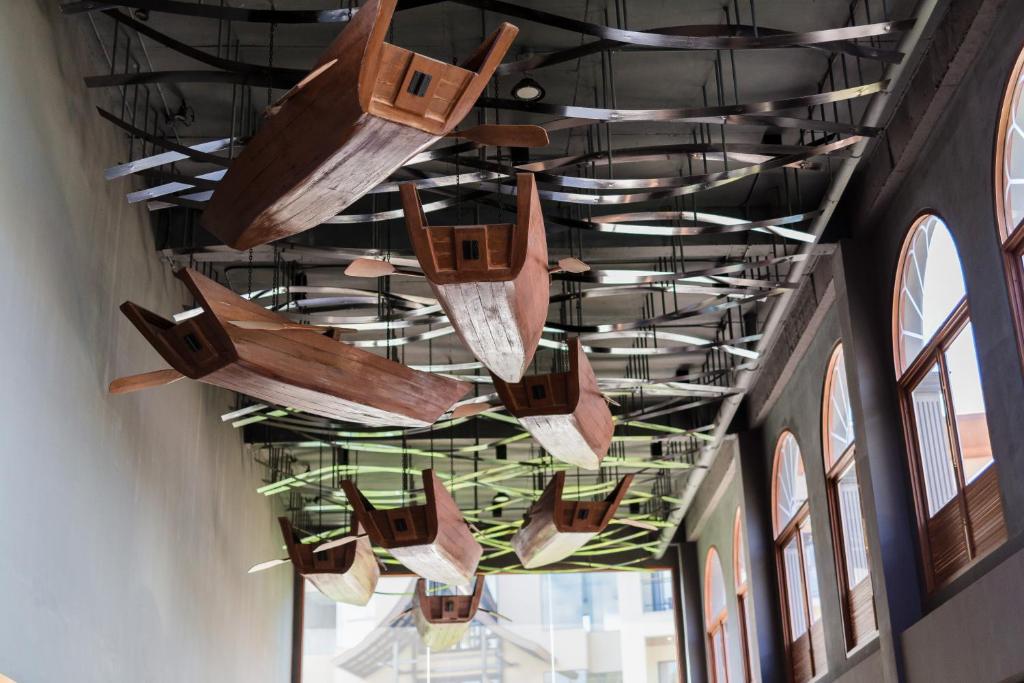 a group of boats hanging from the ceiling of a building at Aurico Kata Resort & Spa - SHA Extra Plus in Kata Beach