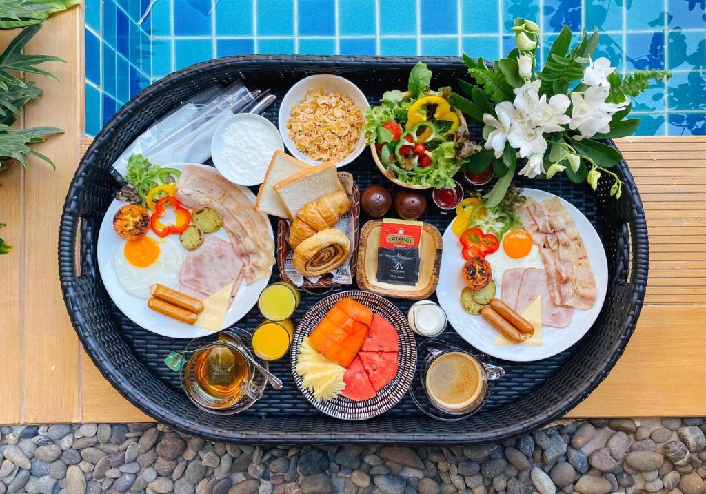 a tray of food with different types of food at Aurico Kata Resort & Spa - SHA Extra Plus in Kata Beach
