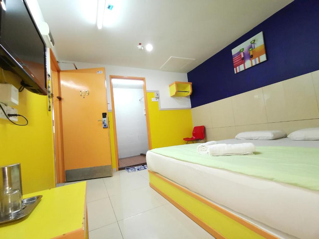 Postel nebo postele na pokoji v ubytování Hotel Abby IGB Tasek