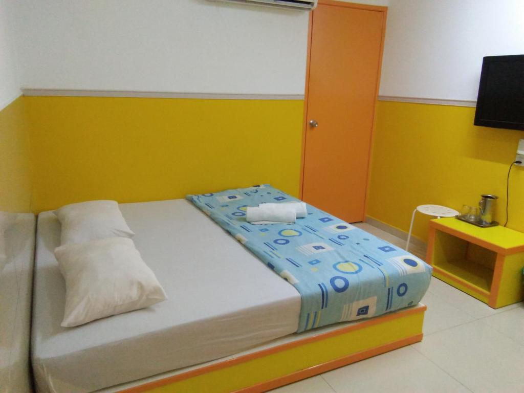 Postel nebo postele na pokoji v ubytování Hotel Abby IGB Tasek