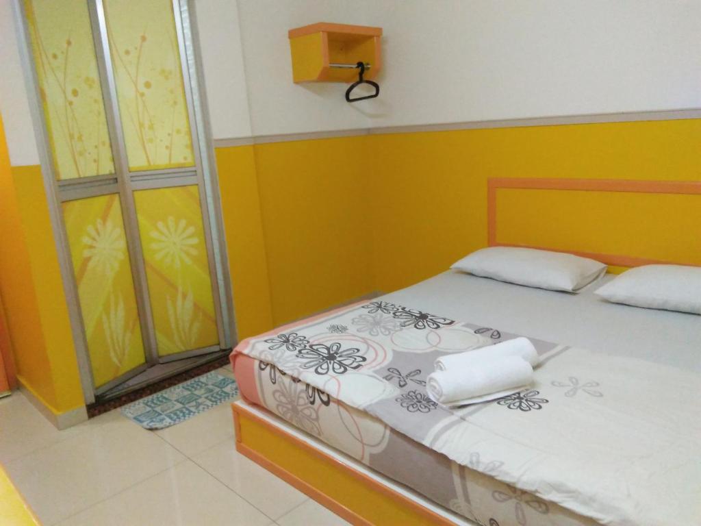 Postel nebo postele na pokoji v ubytování Hotel Abby IGB Tasek
