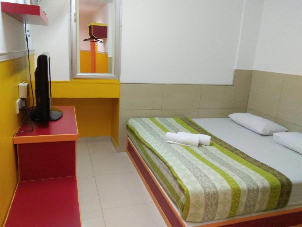 Postel nebo postele na pokoji v ubytování Hotel Abby IGB Tasek