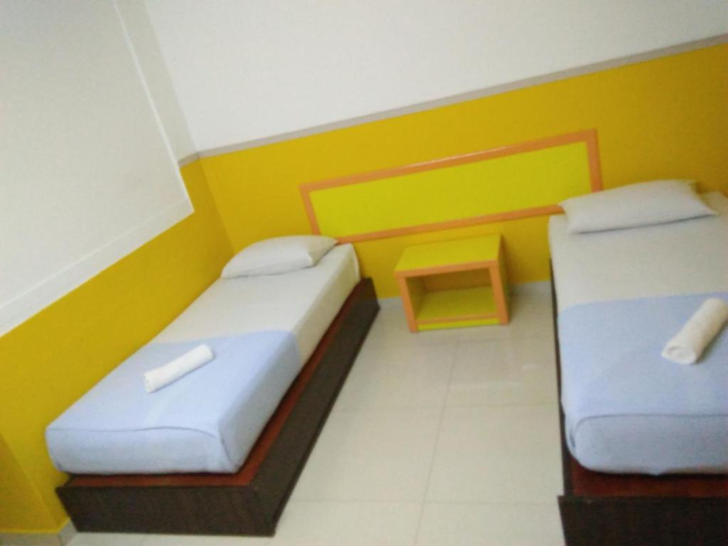Postel nebo postele na pokoji v ubytování Hotel Abby IGB Tasek