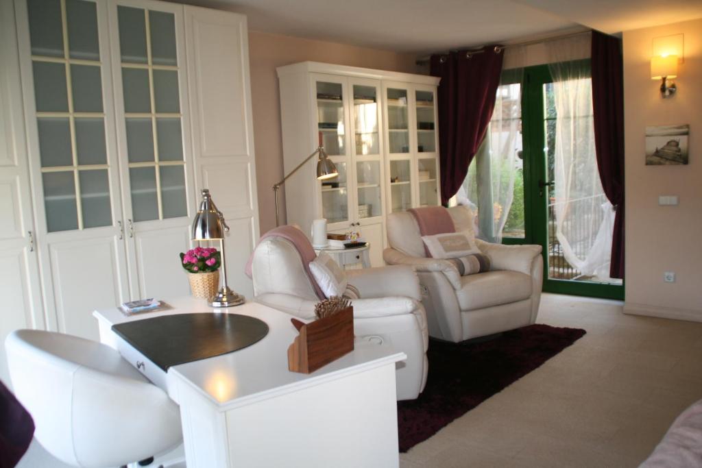 a living room with couches and a table and chairs at B&B Sallent in Sallent del Llobregat