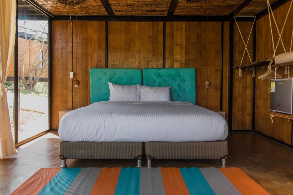 Una cama o camas en una habitación de Hotel Resort Del Cafe