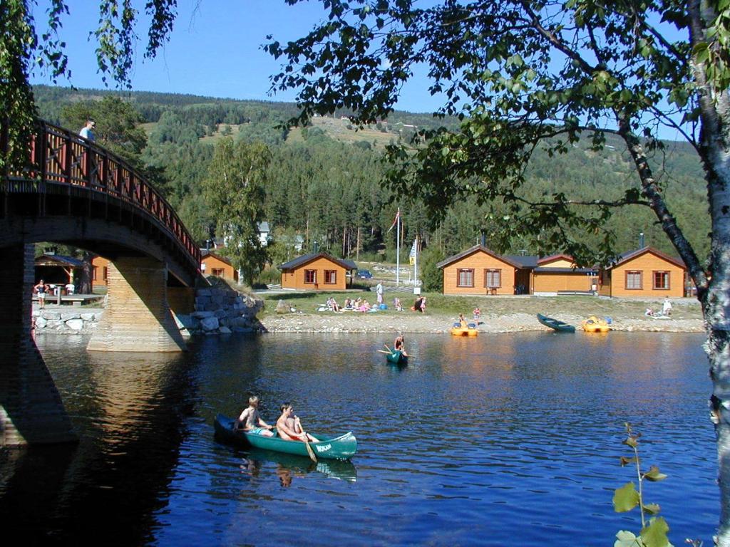 two people in canoes on a river under a bridge at Camp Uvdal in Uvdal