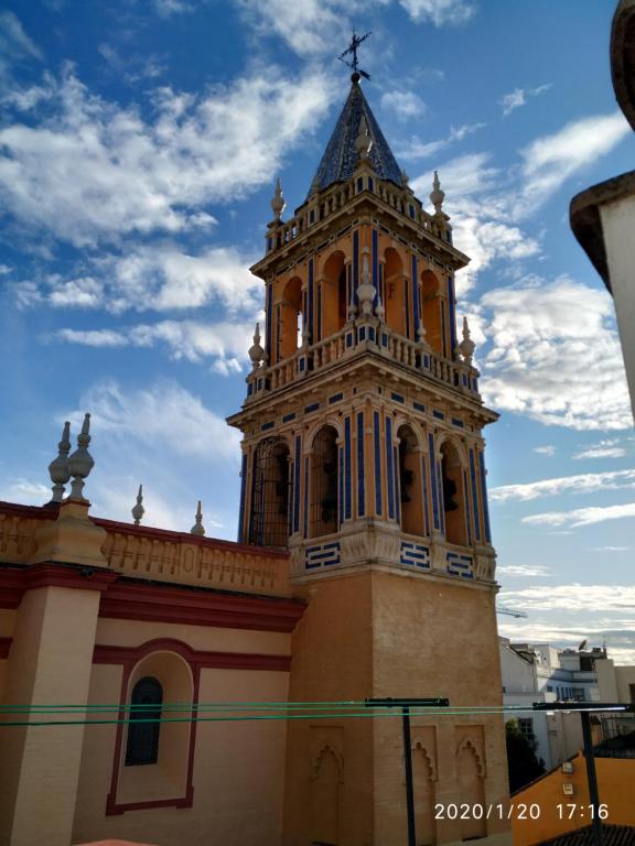 Una iglesia con una torre encima. en Triana Cathedral House, en Sevilla