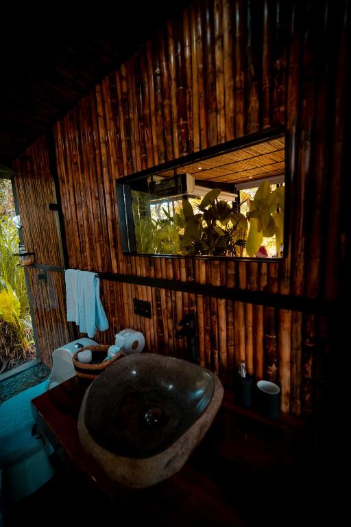 a bathroom with a sink in a wooden wall at Bio Habitat Hotel in Armenia