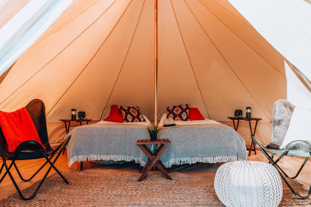a bedroom with two beds in a tent at Wander Camp Grand Canyon in Valle