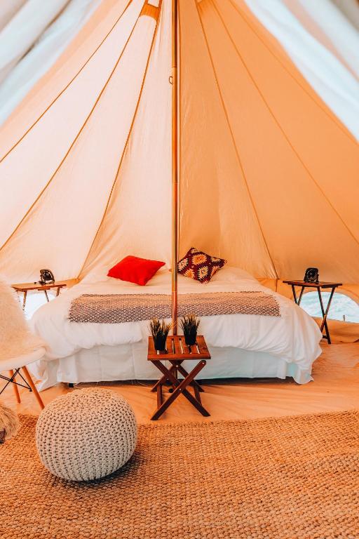 a bedroom with a tent with a bed and a table at Wander Camp Grand Canyon in Valle
