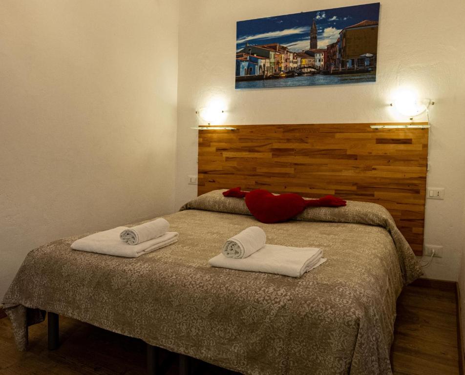a bedroom with a bed with two towels on it at Ca' del Megio in Venice