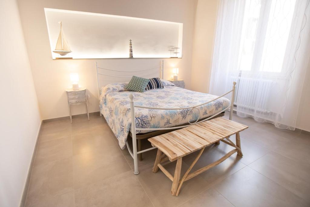 a small bedroom with a bed and a table at Piombino 1428 in Piombino
