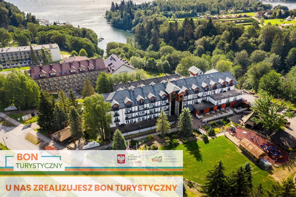an aerial view of a hotel with a river at Hotel Skalny Spa Bieszczady in Polańczyk
