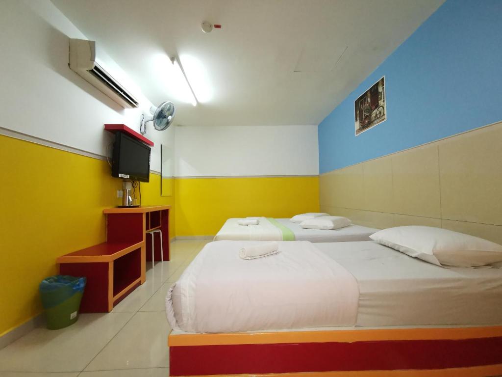 Postel nebo postele na pokoji v ubytování Hotel Abby IGB Tasek