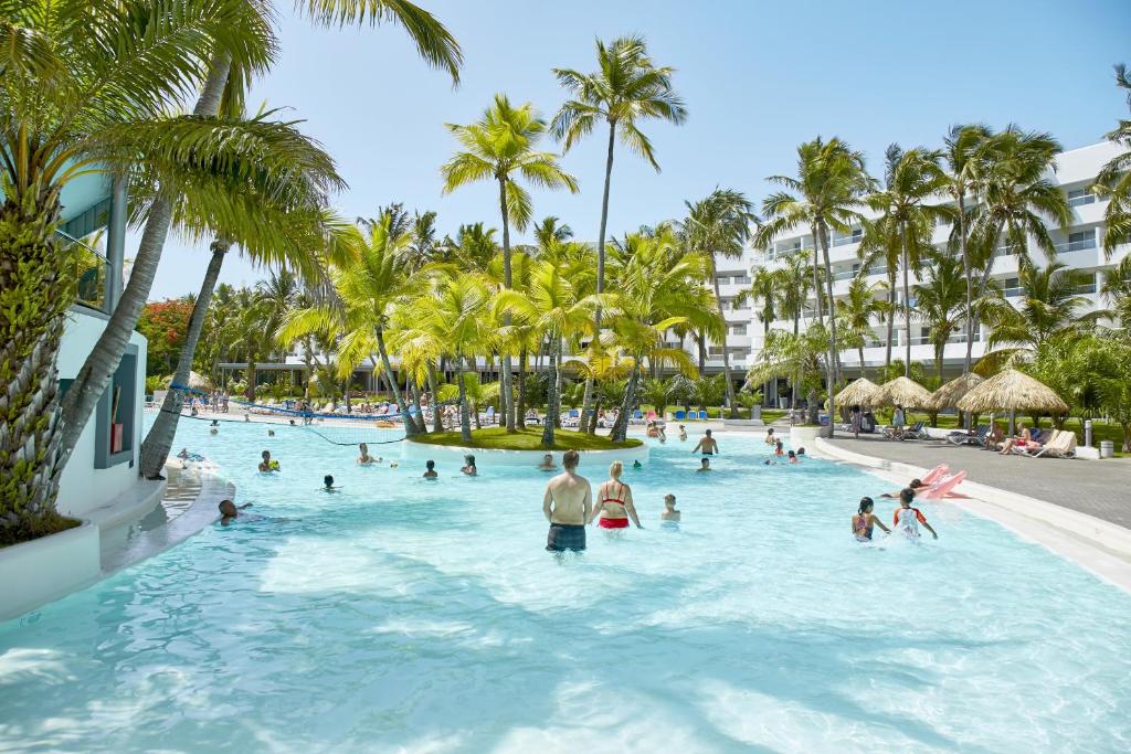 a group of people in a swimming pool at a resort at Riu Naiboa - All Inclusive in Punta Cana