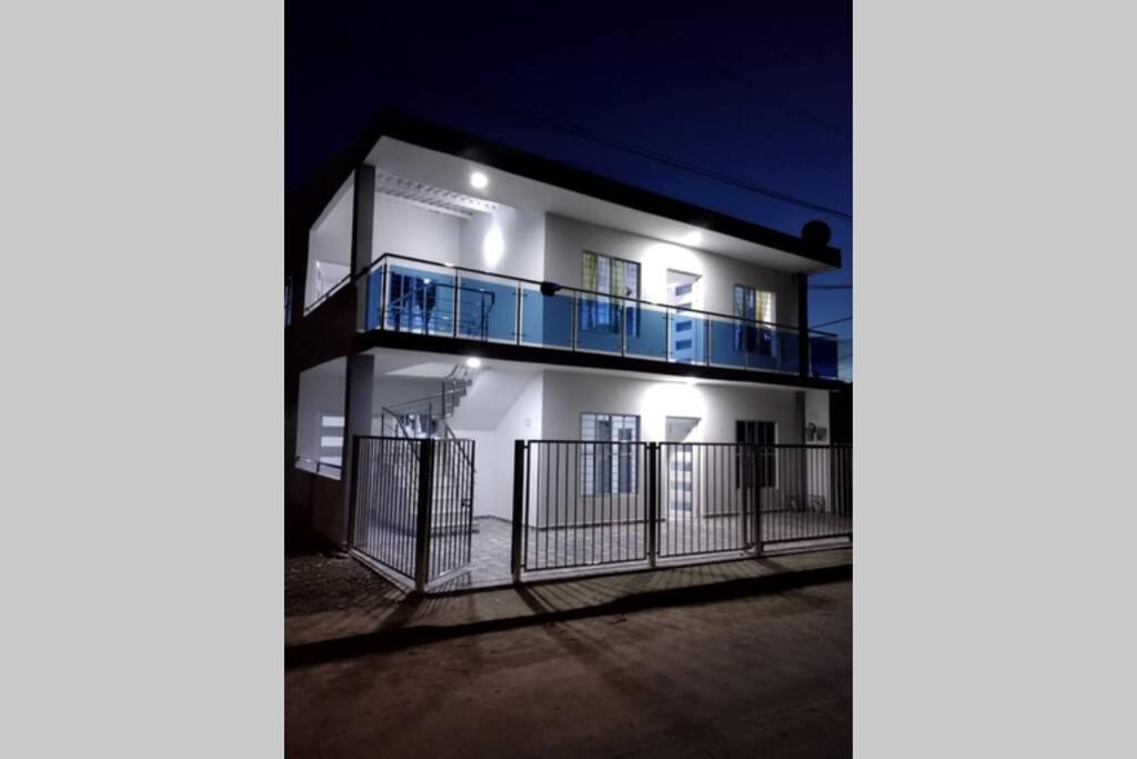 an apartment building with a balcony at night at Cabañas Chavita PISO 1 Coveñas in Coveñas