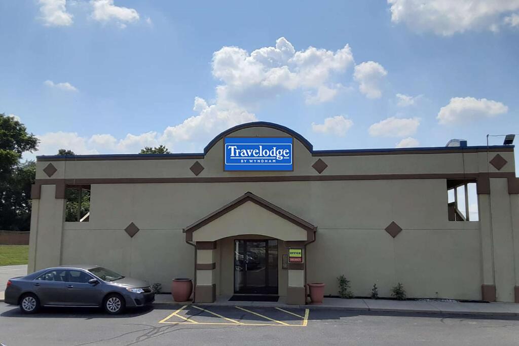 a car parked in front of a car dealership at Travelodge by Wyndham Richmond IN in Richmond