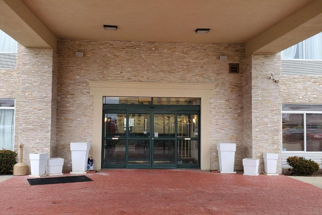 a building with a glass door and a brick wall at Comfort Inn & Suites Decatur-Forsyth in Forsyth