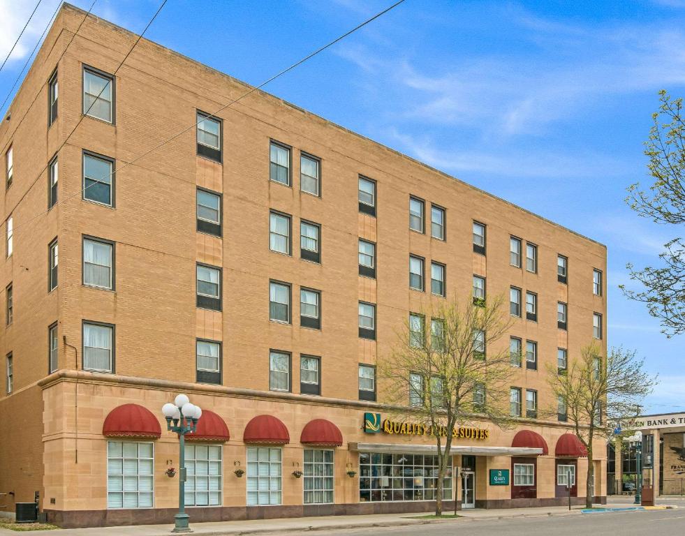 a large brick building with red awnings at Quality Inn & Suites in Virginia