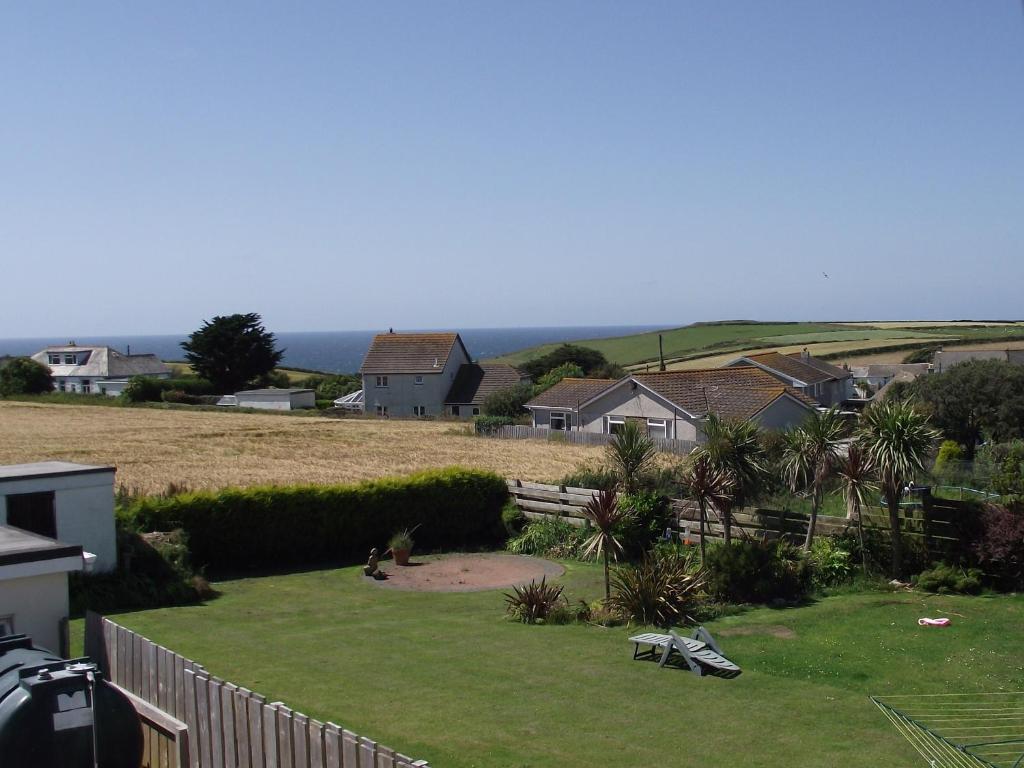 a view of a yard with a fence and houses at Trevarrian Lodge in Newquay