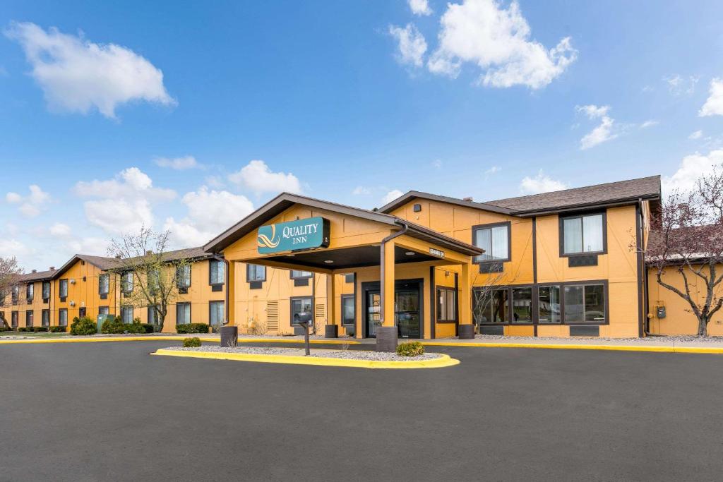 a building with a sign on the front of it at Quality Inn in Marquette