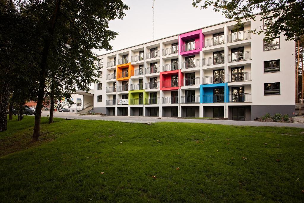 a building with colorful balconies on the side of it at Oblacka Przystań in Lubliniec