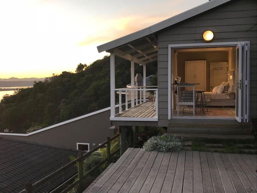 a house with a deck with a view of the ocean at Knysna Heads Private Suite in Knysna