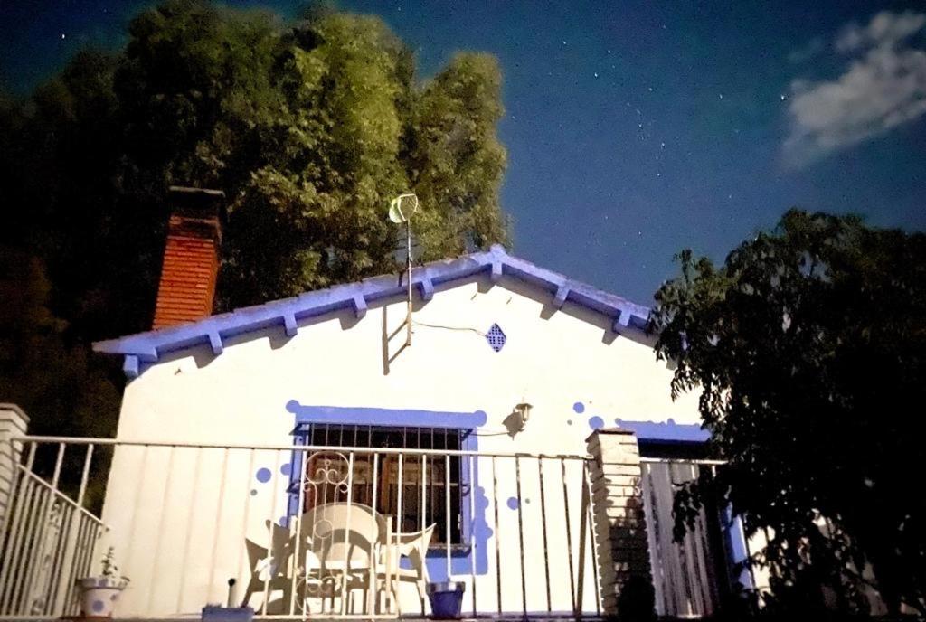 a white house with a fence in front of it at La Casa de Las Burbujas Azules in Caspe