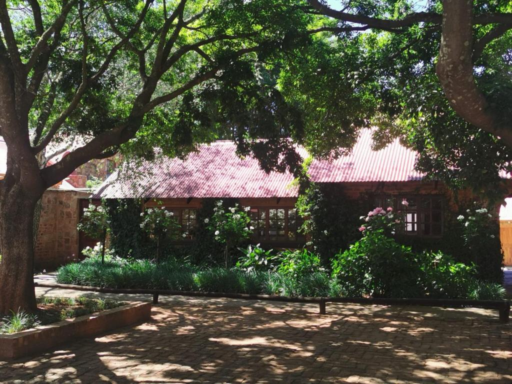 a house with a red roof in a park at Critchley Hackle Dullstroom Leisure in Dullstroom