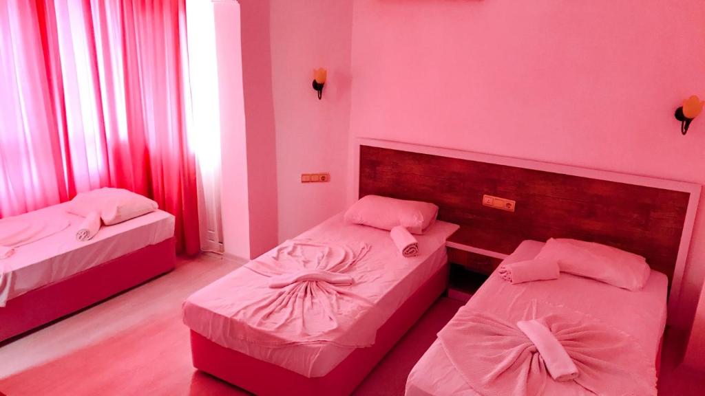 A bed or beds in a room at Best Alanya Hotel