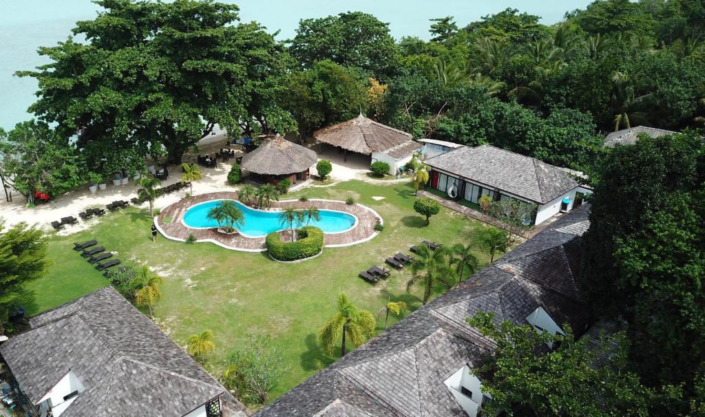an aerial view of a house with a swimming pool at The Reef Resort in Koh Kradan