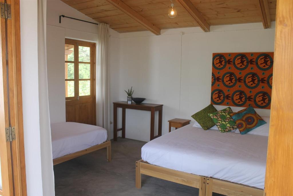 Postel nebo postele na pokoji v ubytování La Fora Ecolodge