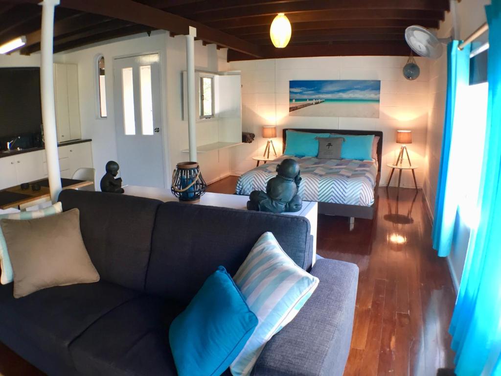 a living room with a couch and a bed at High Tide at Emerald in Emerald Beach