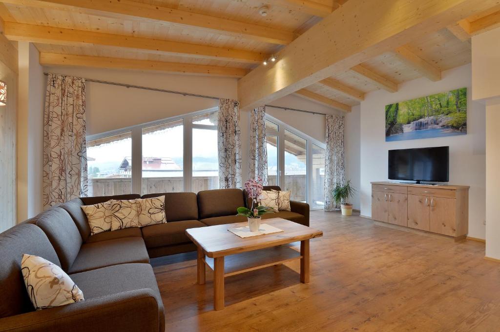 a living room with a couch and a table at Appartement Fuchs Ferdinand in Ellmau